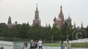 Personas en un parque de Rusia, con la catedral de San Basilio y el Kremlin al fondo